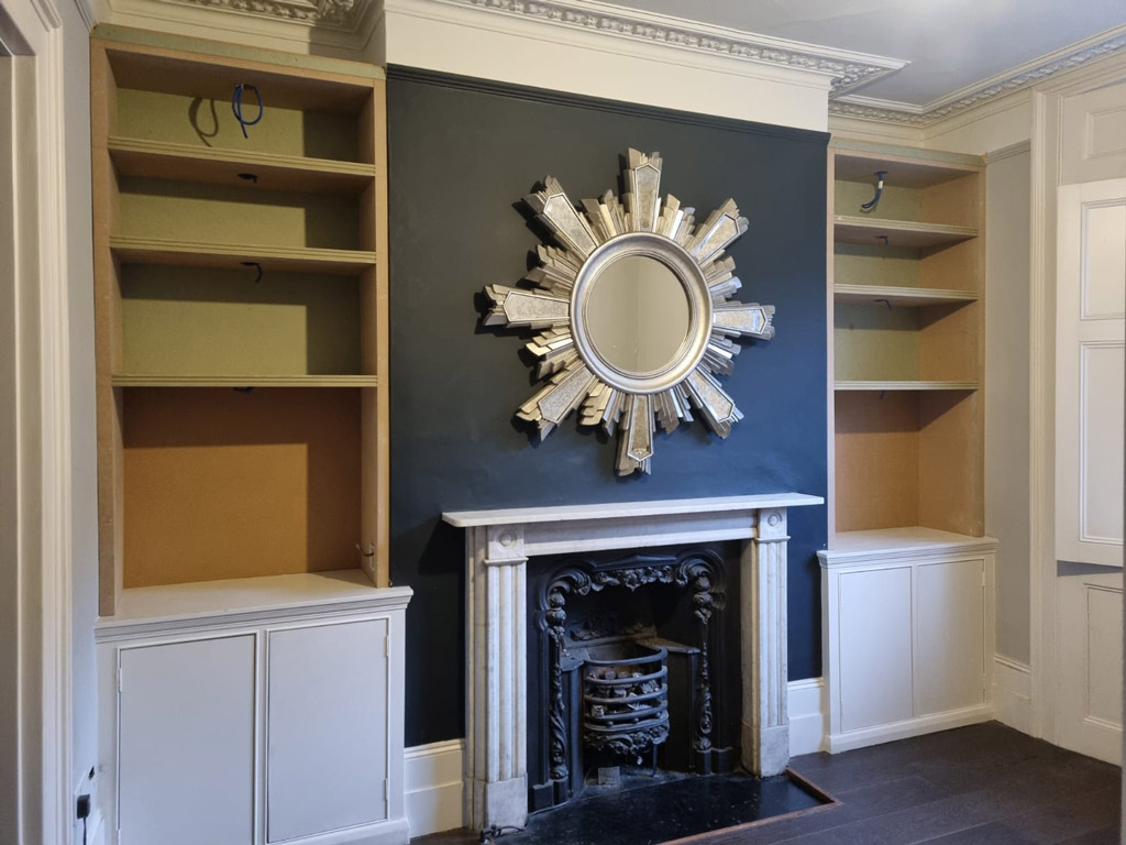 Chimney breast fitted alcove cupboards in London - Ready to be painted.